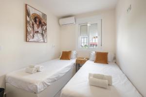 a room with two beds and a window at Villa Cobo in Torremolinos +35 photos