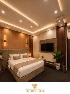 a hotel room with a large bed and a flat screen tv at Lotus Apartments l New Cairo in Cairo