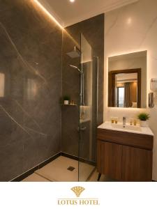 a bathroom with a shower and a sink at Lotus Apartments l New Cairo in Cairo +12 photos