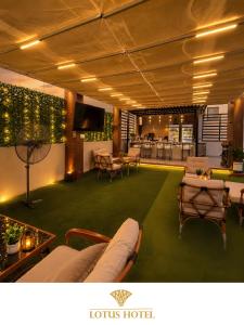 a hotel lobby with couches and tables and a bar at Lotus Apartments l New Cairo in Cairo