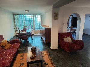 a living room with two couches and a dining room at La Oliva in San Martín
