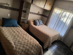 a small bedroom with two beds and a window at La Oliva in San Martín +11 photos