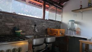 a kitchen with a sink and a stove at Pisac cosmic in Pisac