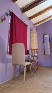 a dining room with a table and a chair at Pisac cosmic in Pisac