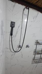 a shower in a bathroom with a black shower head at Pisac cosmic in Pisac