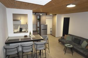 a kitchen and living room with a couch and a table at Blue Yard in Lepetani