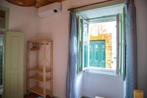 a room with a window and a book shelf at Casa do Arco da Vila in Faro +30 photos