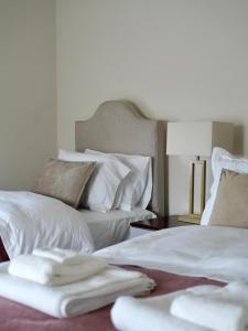two beds in a room with white sheets and pillows at Carland Cottage in Carland