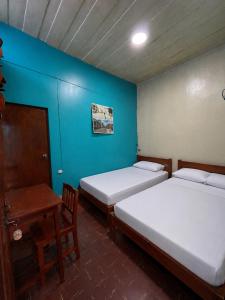 A bed or beds in a room at The Grindio Hostel