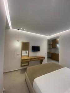 a bedroom with a bed and a tv on the wall at Villa Xani in Himare