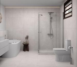 a bathroom with a shower and a toilet and a sink at Iririki Island Resort & Spa in Port Vila