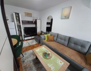 a living room with a couch and a table at Apartment Meri with garage in Velika Kladuša