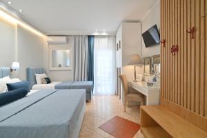 a hotel room with a bed and a desk at Epavlis Luxury apts in Leptokarya