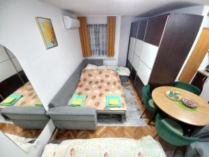 a small room with two beds and a table at Apartment Meri with garage in Velika Kladuša