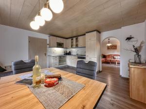 a kitchen and dining room with a table with a bottle of wine at Bayerischer Wald in Waldkirchen