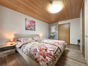 a bedroom with a large bed and a wooden ceiling at Bayerischer Wald in Waldkirchen