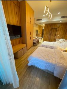 a large bedroom with a large bed and a television at The Gate 05 New Alamein in El Alamein