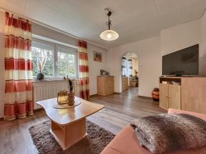 a living room with a couch and a tv at Bayerischer Wald in Waldkirchen