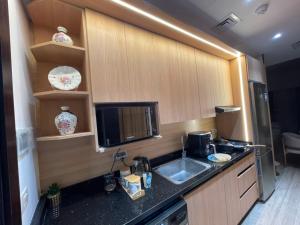 a kitchen with a sink and a microwave at The Gate 05 New Alamein in El Alamein