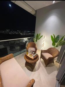 a living room with wicker chairs and a table at The Gate 05 New Alamein in El Alamein +3 photos