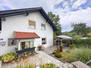 a white house with a patio and a garden at Bayerischer Wald in Waldkirchen