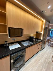 a kitchen with a washing machine and a sink at The Gate 05 New Alamein in El Alamein