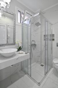 a bathroom with a glass shower and a sink at Epavlis Luxury apts in Leptokarya +147 photos