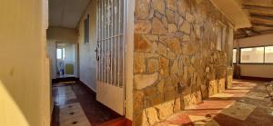 a room with a stone wall and a hallway at appart villa galactik pegasus in Aourir +12 photos
