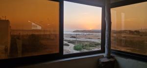 a view of a beach from a window at appart villa galactik pegasus in Aourir