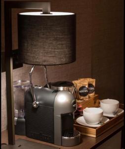 a lamp sitting on a table next to a toaster at Kingfisher Beach Resort-Yala Safari in Kirinda