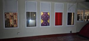 a wall with four windows in a room at appart villa galactik pegasus in Aourir