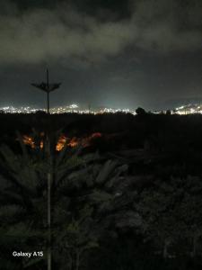 a cross on top of a hill at night at appart villa galactik pegasus in Aourir
