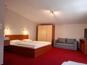 a hotel room with a bed and a chair at Pensiune Safrane in Băile Herculane +41 photos