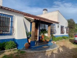 a white and blue house with a porch at Monte do Laranjal in Monsaraz