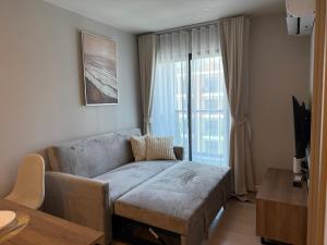 a living room with a couch and a window at RJ Space in Ban Thalat Choeng Thale +45 photos