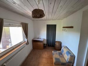 a room with a bed and a desk and a window at Čejkovický domek in Čejkovice