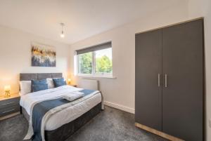 a bedroom with a large bed and a window at St John's Flats, Newsome in Huddersfield