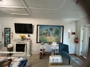 a living room with a desk and a tv on the wall at Studio Wendy in Bradenton