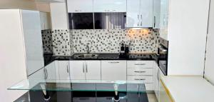 a kitchen with white cabinets and a sink at Villa imperial in Ravanj +52 photos