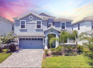 a large blue house with a garage at Disney 8BR South Pool Theater Arcade Harry Potter Room in Davenport