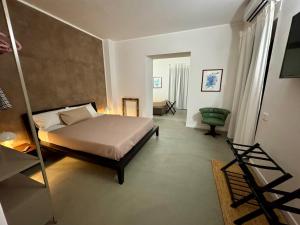 a bedroom with a bed and a chair in it at Nice Sea Suite in Salerno