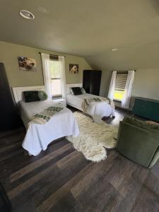 a bedroom with two beds and a rug at The Perfect Match River Retreat in Buffalo City