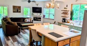 a kitchen and living room with a couch and a table at Private Beach, secluded! in Covington