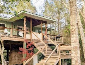 a tree house with stairs leading up to it at Private Beach, secluded! in Covington