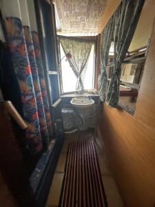 a small bathroom with a sink and a window at FARE Tatahi in Parea