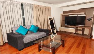 a living room with a couch and a flat screen tv at HOTEL MURCIA AREQUIPA in Arequipa