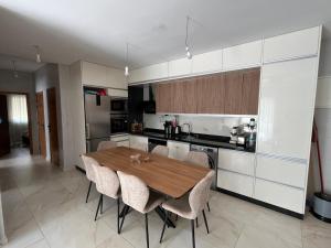 a kitchen with a wooden table and some chairs at Nour House Imi Ouaddar in Agadir nʼ Aït Sa