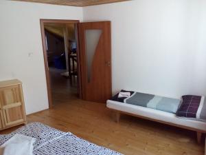 A bed or beds in a room at Ubytovanie Hugo Alžbetka