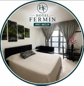 a hotel room with a bed and a sign at Hotel Fermín in Santa Rosa de Cabal