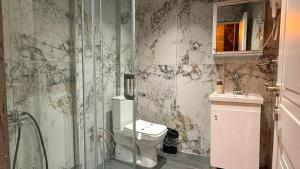 a bathroom with a toilet and a glass shower at Viyana Suite Hotel in Istanbul +34 photos